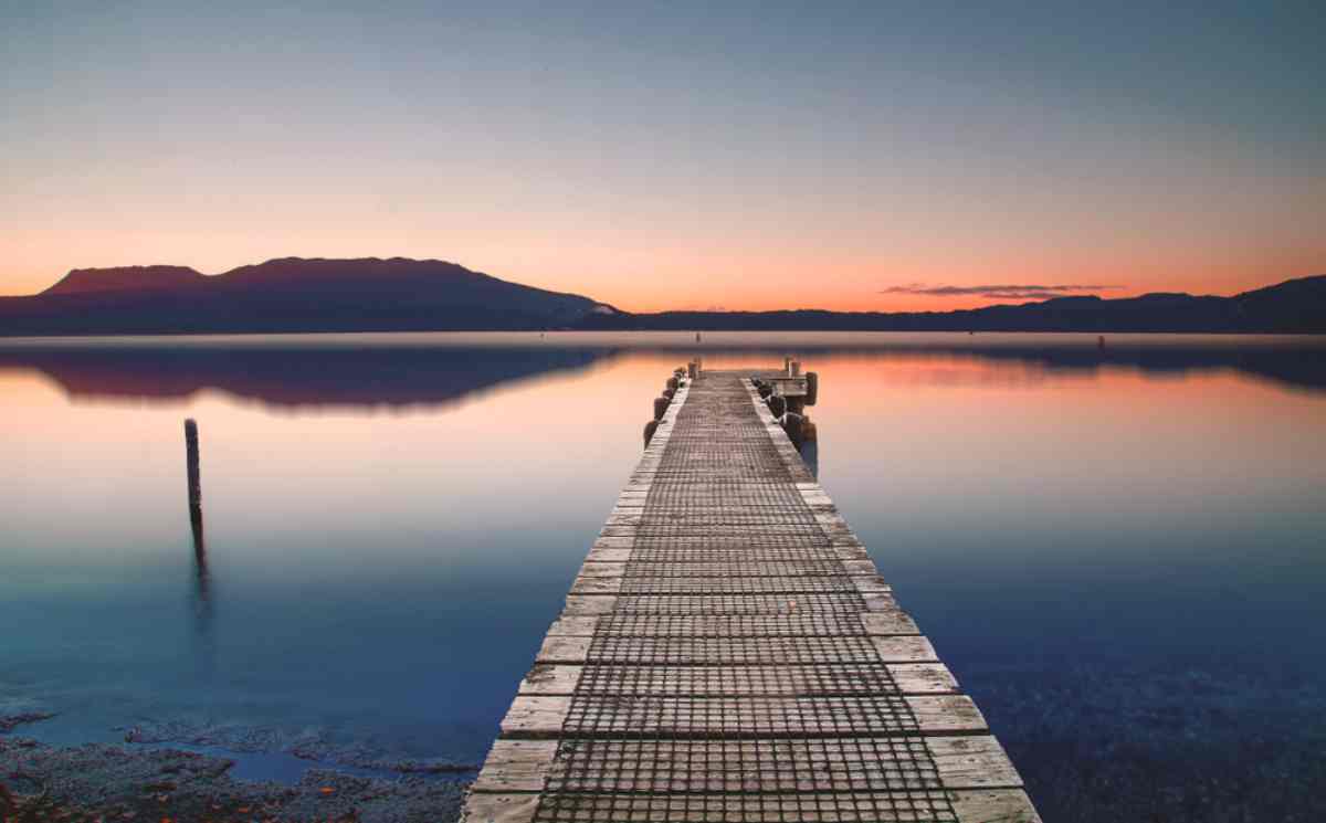 Beautiful lake with a dock in Rotorua at dusk 