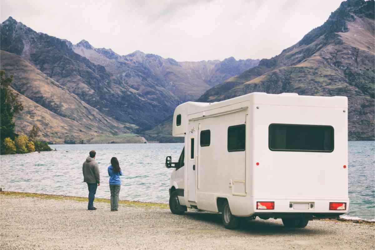 Campers with their RV parked by a lake in NZ